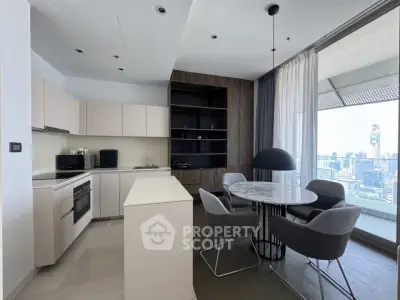 Modern kitchen with open layout and city view, featuring sleek cabinetry and stylish dining area.