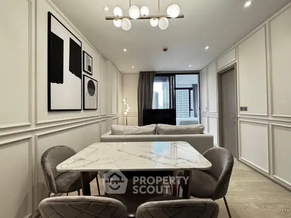 Modern living room with elegant decor and city view, featuring stylish furniture and contemporary lighting.
