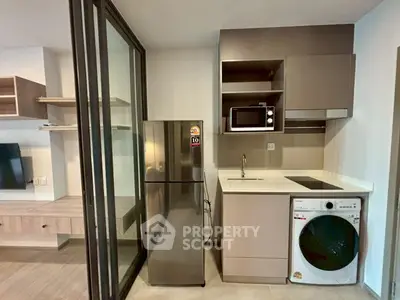Modern kitchen with sleek appliances and open layout in stylish apartment