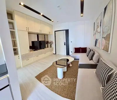 Modern living room with stylish decor, spacious seating, and built-in storage in a contemporary apartment.