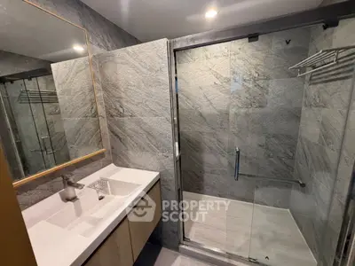 Modern bathroom with sleek glass shower and elegant vanity