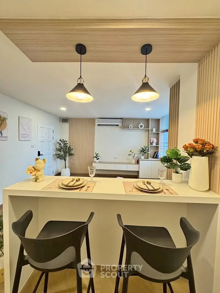 Modern living room with stylish dining area and elegant lighting