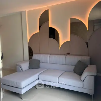 Modern living room with stylish sofa and unique wall lighting design