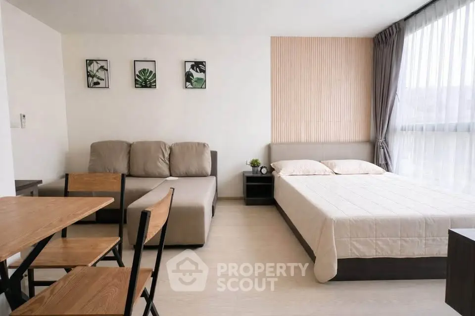 Modern studio apartment with cozy living area and stylish decor