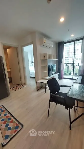 Modern apartment interior with open living area and balcony view