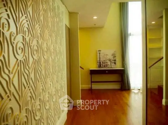 Stylish interior with decorative wall panel and wooden flooring in a modern home.
