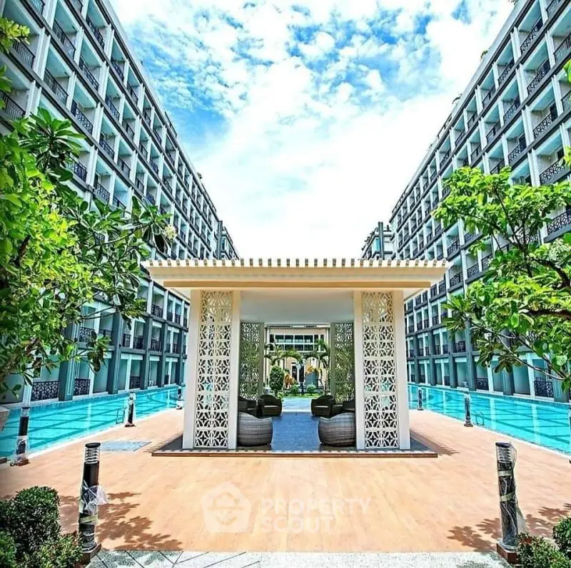 Luxurious modern apartment complex with stunning pool and lush greenery