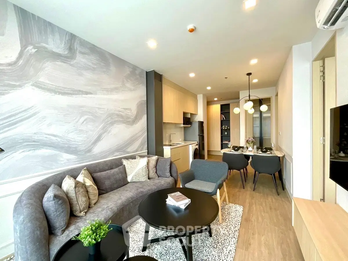 Modern living room with stylish decor and open kitchen layout in a contemporary apartment.