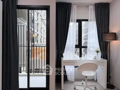 Modern study area with sleek desk and balcony view in urban apartment