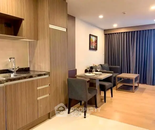 Modern open-layout kitchen and dining area with stylish wood cabinetry and cozy seating.