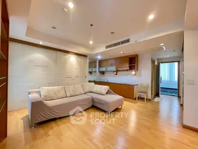 Spacious living room with modern sofa and open kitchen layout