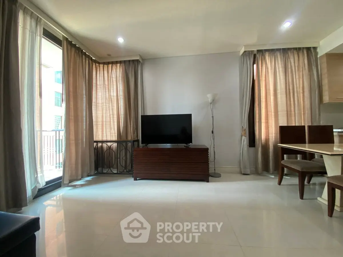 Spacious living room with natural light and modern furnishings in a stylish apartment.