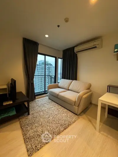 Modern living room with city view, cozy sofa, and air conditioning in high-rise apartment.