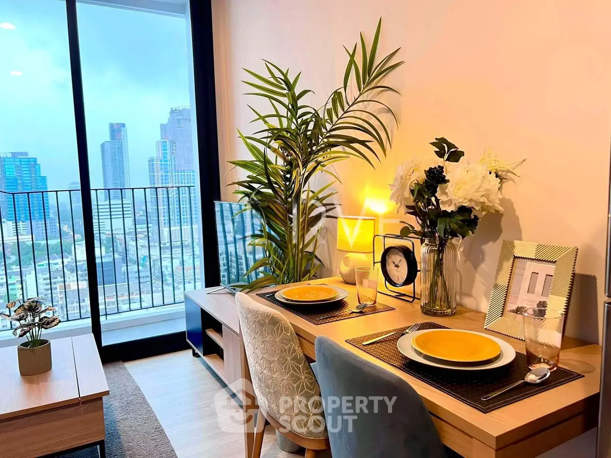 Modern living room with city view, stylish decor, and cozy dining setup.