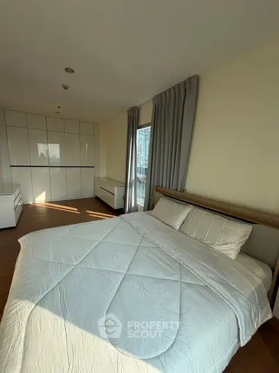 Spacious bedroom with modern design and ample natural light