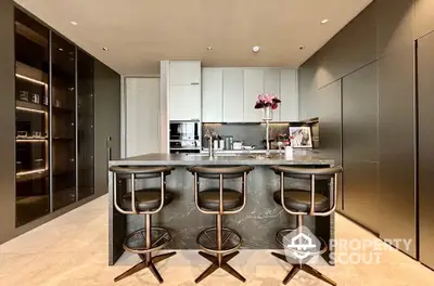 Luxurious modern kitchen with sleek black cabinetry and stylish bar stools