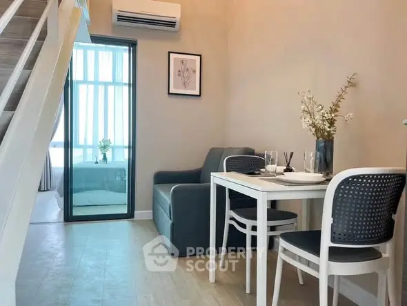 Modern living room with dining area and staircase in stylish apartment