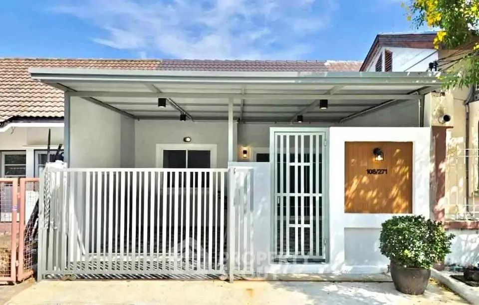 Charming single-story home with modern facade and gated entrance