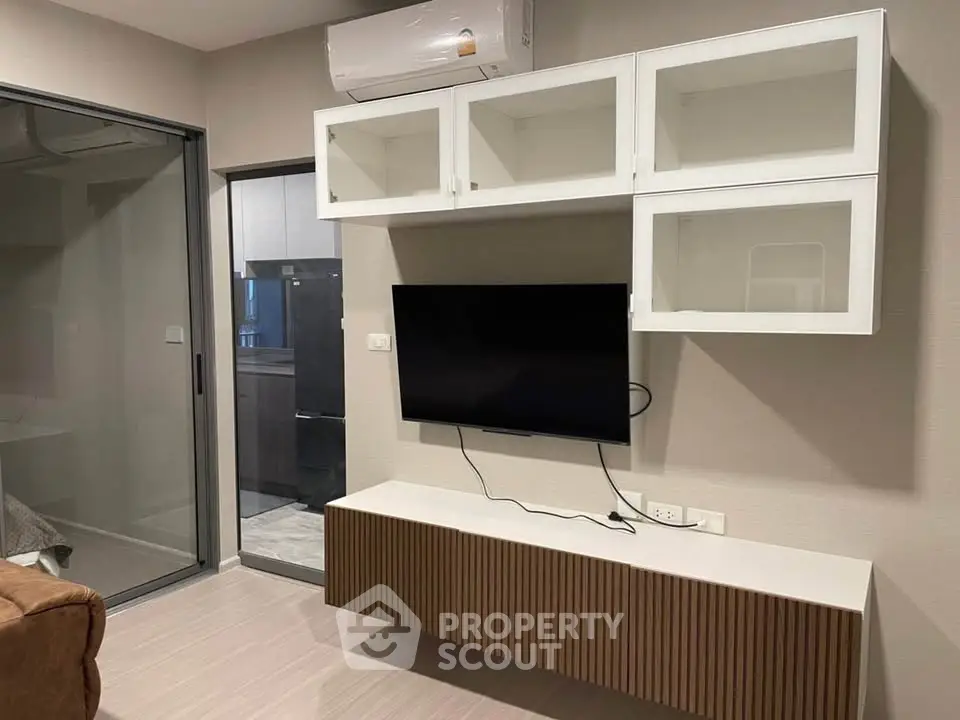 Modern living room with wall-mounted TV and sleek cabinetry