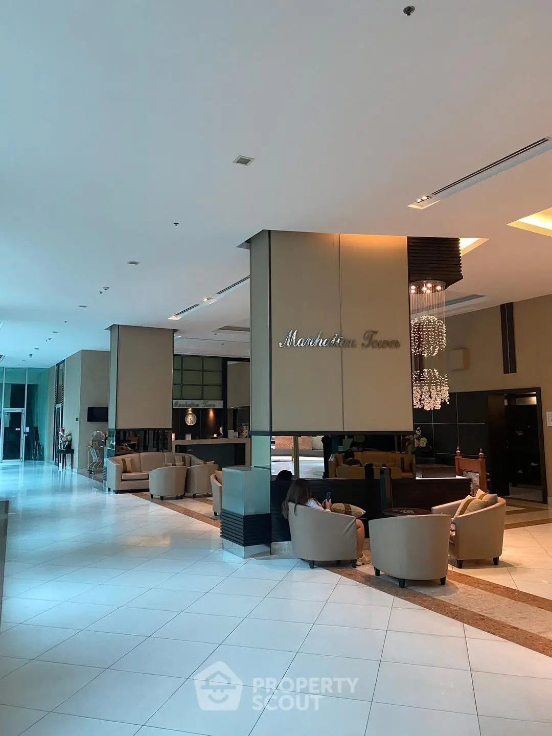 Luxurious apartment lobby with elegant seating and chandelier lighting