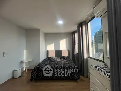 Modern bedroom with large window and stylish decor