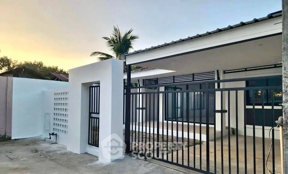 Modern single-story house with gated entrance and minimalist design, perfect for serene living.