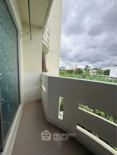 Charming balcony with safety netting and scenic view, perfect for relaxation and enjoying fresh air.