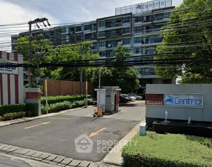 Modern residential building with lush greenery and secure entrance at Centrio.