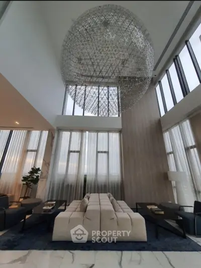 Luxurious modern living room with high ceilings and stunning chandelier