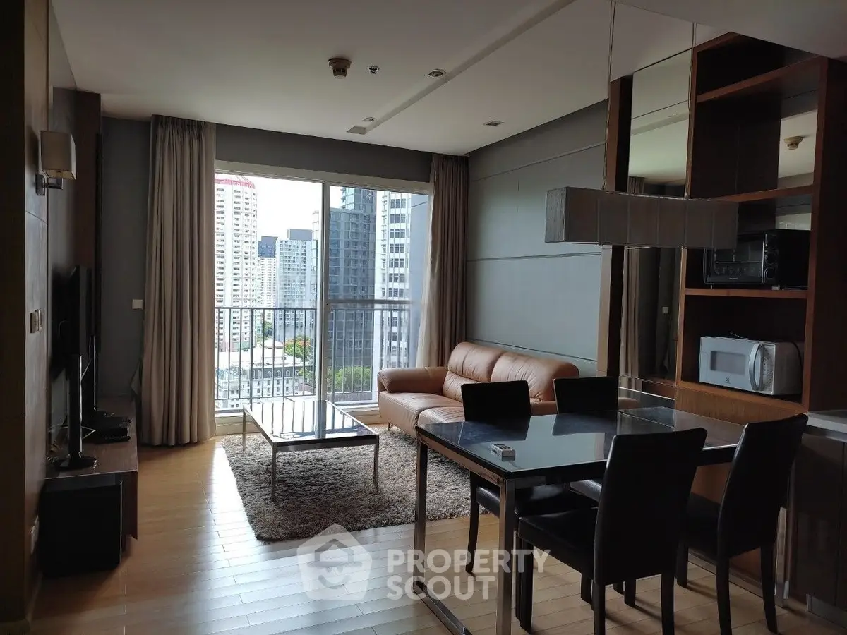 Modern living room with city view, leather sofa, and dining area in a high-rise apartment.