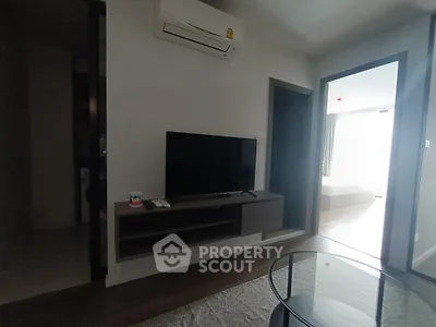 Modern living room with sleek TV setup and air conditioning
