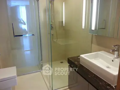 Modern bathroom with glass shower and sleek fixtures