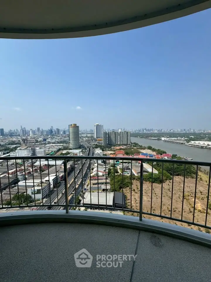 Stunning cityscape view from a high-rise balcony overlooking the river and skyline.