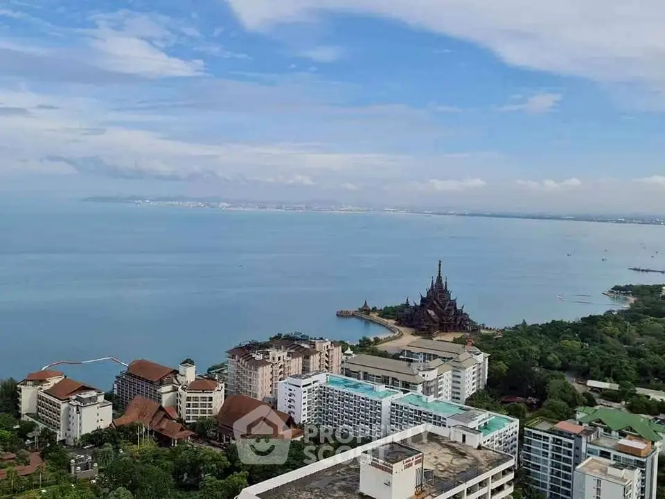 Stunning aerial view of coastal cityscape with ocean and iconic temple