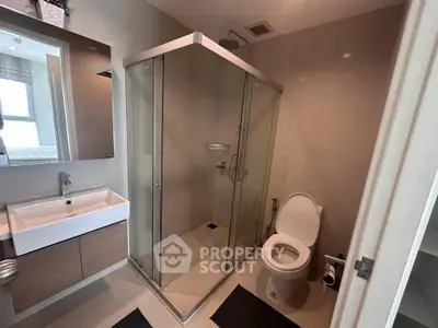 Modern bathroom with glass shower enclosure and sleek fixtures