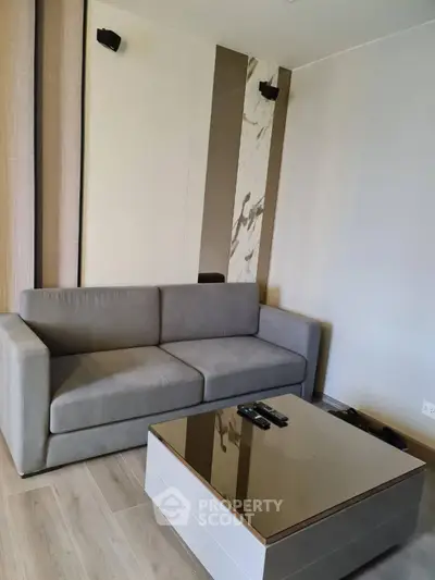 Modern living room with sleek gray sofa and stylish coffee table