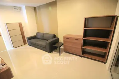 Modern living room with sleek furniture and neutral tones, perfect for a cozy and stylish home.