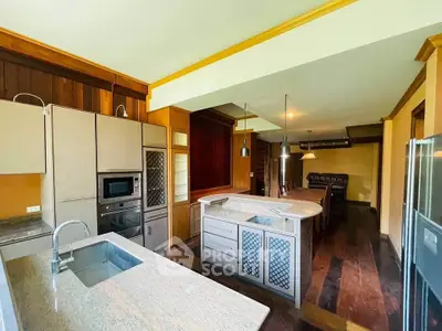 Luxurious kitchen with granite countertops and modern appliances in a spacious open layout.