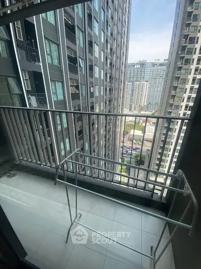 Modern high-rise balcony with city view, ideal for urban living.