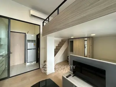 Modern loft-style apartment with open layout and sleek design, featuring a mezzanine and stylish kitchen area.