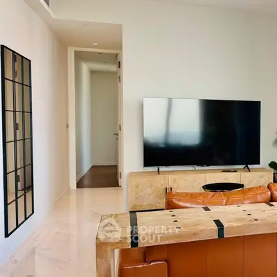 Modern living room with sleek TV setup and stylish leather furniture