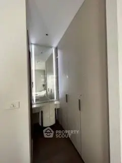 Modern hallway with sleek storage and elegant mirror design