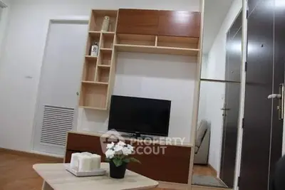 Modern living room with stylish wooden shelving and flat-screen TV, perfect for cozy relaxation.