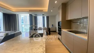 Luxurious open-plan kitchen and living area with modern design and city view.