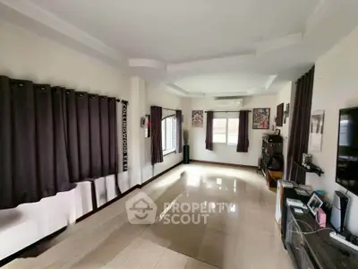 Spacious living room with modern decor and large windows for natural light.