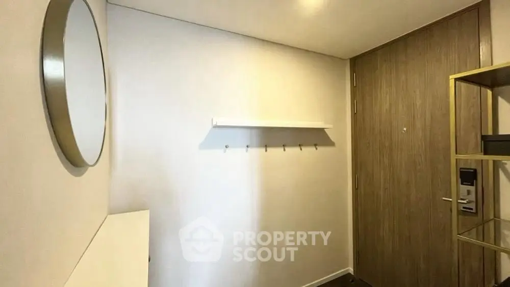 Modern apartment entrance with sleek wooden door and minimalist decor