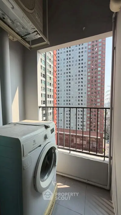 High-rise apartment balcony with washing machine and city view