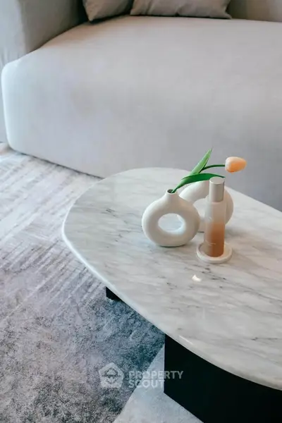 Elegant living room with modern marble coffee table and stylish decor