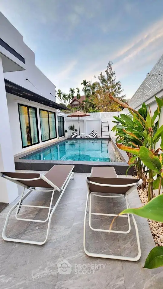 Luxurious modern villa with private pool and stylish outdoor seating area.