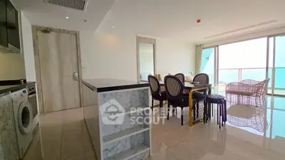 Spacious modern kitchen with dining area and ocean view balcony